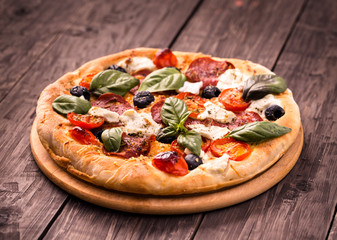 Pizza with salami and mozzarella rustic style