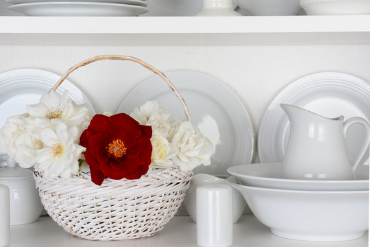 White Plates in Cupboard and One Red Rose