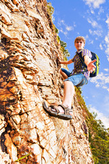 Close up of a man climbing up red rock
