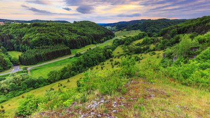 Fototapeta na wymiar Stunning Summer Evening Landscape in the rural Countryside of Bamberg. Lovely green and blue colors near a picturesque country road