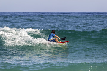 Ocean view and people surfing in Tavira Island beach, Algarve