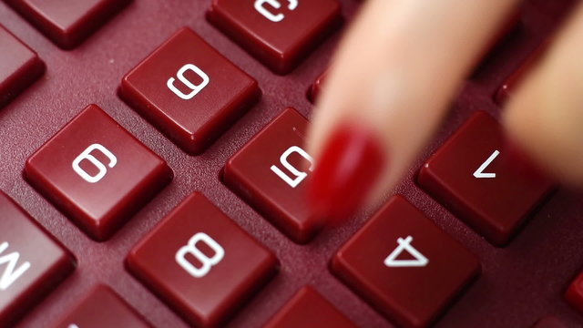 finger pushing calculator buttons, extra close up