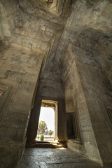 Ancient corridor with arch vault in Angkor Wat temple tower.