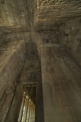 Ancient corridor with arch vault in Angkor Wat temple tower.