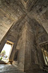 Ancient corridor with arch vault in Angkor Wat temple tower.