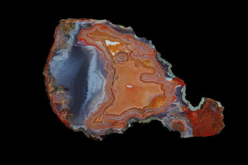 A cross section of agate stone with geode on a black background.  Origin:  Morocco, Asni.