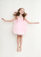 Naklejka premium Cute girl in fairy costume posing in the studio
