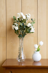 Fake flowers for decoration on wooden table
