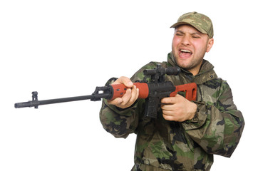 Fototapeta premium Young man in soldier uniform holding gun isolated on white