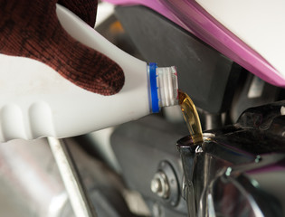 Naklejka premium Fill oil to the engine after driving motorcycle