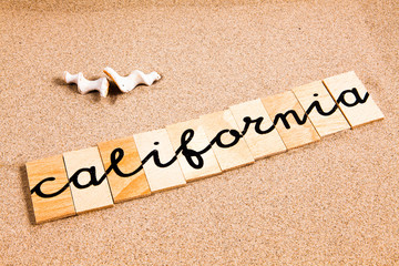 Words formed from small pieces of wood containing a sun and beach tourist destination, California