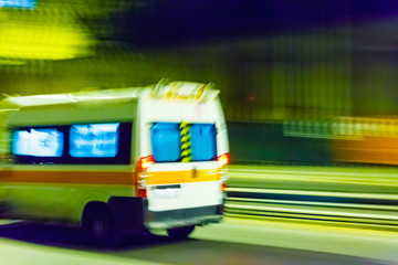 An ambulance speeding through traffic at nighttime © Maksim Shebeko