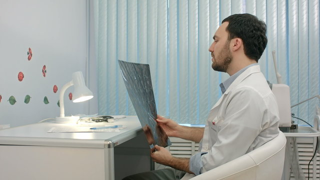 Doctor looking at the x-ray picture of lungs in hospital