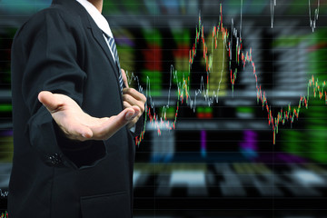Business Man hand holding with stock market graph background