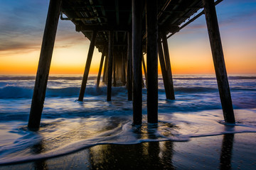 Waves under the fishing pier at sunset, in Imperial Beach, Calif