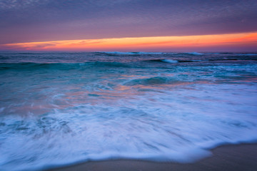 Waves in the Pacific Ocean at sunset, in La Jolla, California.