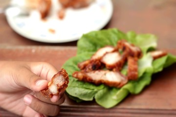 Pork fried with vegetables in hand.