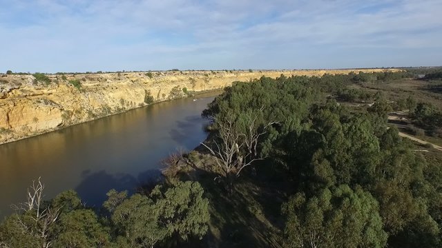 Aerial video footage of river murray cliffs at big bend near nildottie tracks from tree tops to water ski and wake board