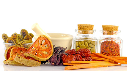 Herbal Medicine tablet and dried herbs.