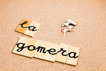 Words formed from small pieces of wood containing a sun and beach tourist destination, La gomera