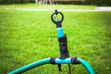 Close up old sprinkler modify on grass