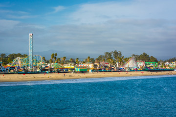 View of the rides on the Santa Cruz Boardwalk and the beach from