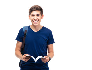 Happy male student holding book - obrazy, fototapety, plakaty