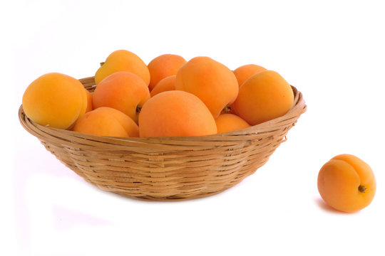Fresh apricots are in a wicker basket