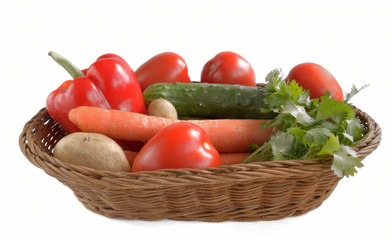 fresh vegetables are in a wicker basket isolated on white backgr