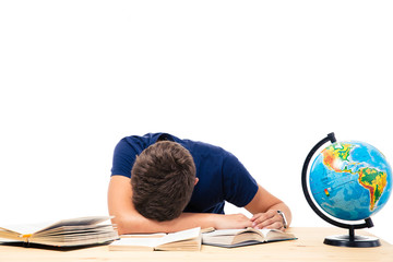 Tired male student sleeping on the table