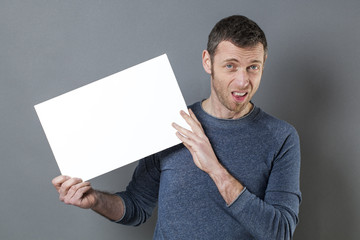disgusted 40s man holding a blank message for sick news