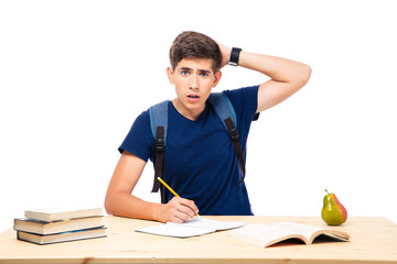 Young male student sitting at the table
