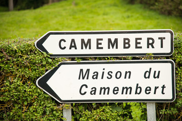 Town sign of the Camembert village, birthplace of famous cheese - obrazy, fototapety, plakaty