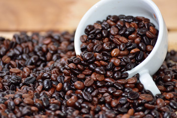 Cup full of coffee beans on the cloth sack