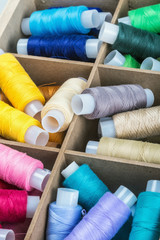 Multicolor sewing threads in a wooden box