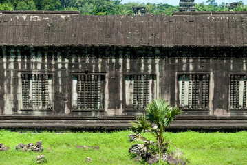 gallery detail with  columns and blind windows of the archaeological place of angkor wat in siam reap, cambodia