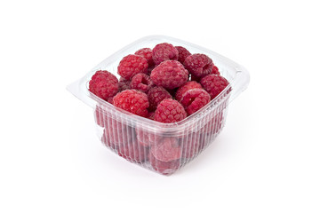 Box or punnet of fresh ripe organic raspberries isolated on white background