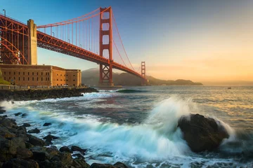 Fotobehang The Golden Gate Bridge, seen at sunrise from Fort Point, San Fra © jonbilous