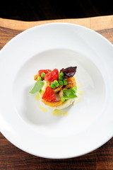 Fine dining, Fried Octopus on potato purree, green peas and fresh strawberries