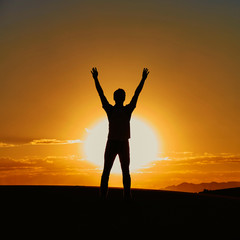 Fototapeta premium Man's silhouette at sunset in desert