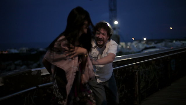 Beautiful woman falling on ground at night on bridge