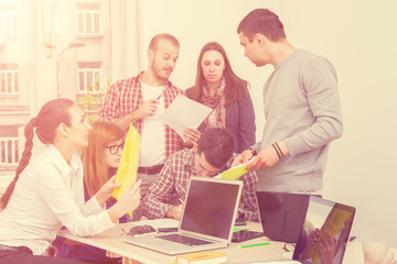 Young group of people discussing business plans.