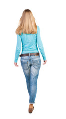 Obraz premium side view of walking woman in jeans.