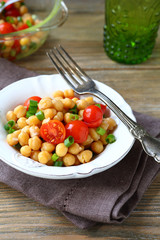 Chickpeas with tomatoes and onions on a plate