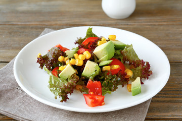 salad with avocado, tomatoes and corn on a plate