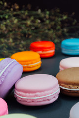 Macaron in a wooden box on black, Vintage tone