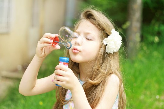 Cute little girl with soap bubbles