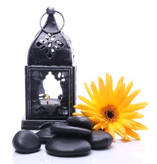 Lantern and black stones on a white background - obrazy, fototapety, plakaty