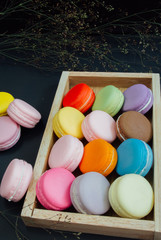 Macaron in a wooden box on black, Vintage tone