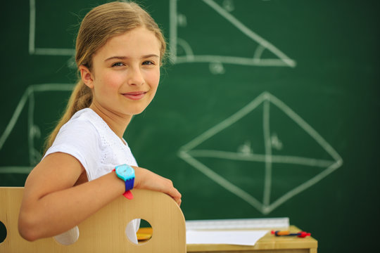 Back to school - young schoolgirl in the classroom